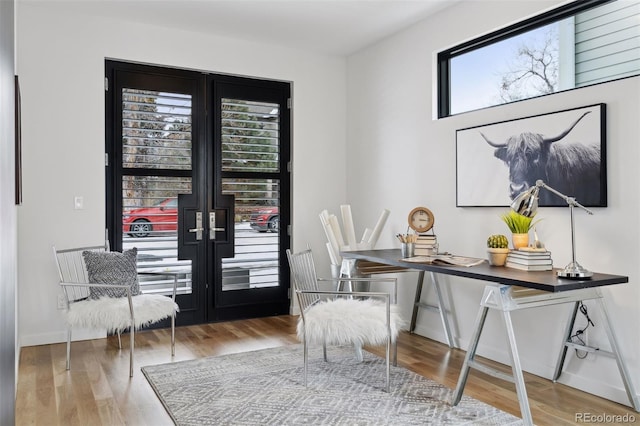 office area with french doors and hardwood / wood-style floors