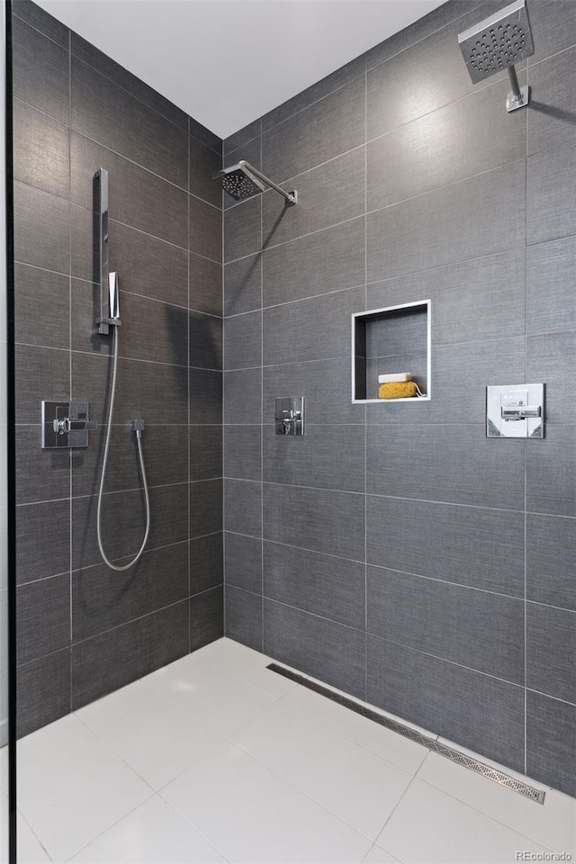 bathroom with tile patterned floors and a tile shower