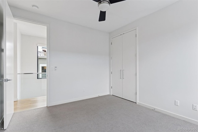 unfurnished bedroom featuring a closet, ceiling fan, and light carpet