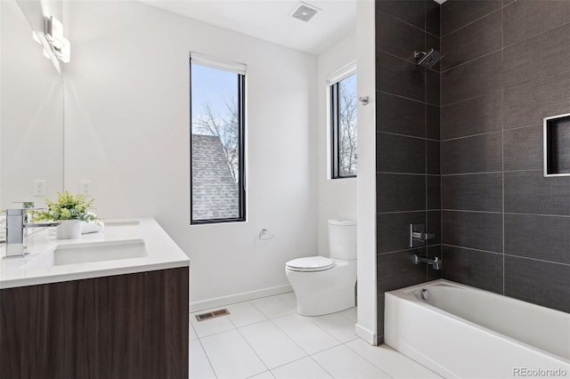 full bathroom with toilet, vanity, tiled shower / bath combo, and tile patterned flooring