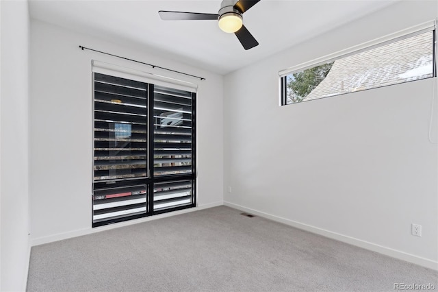 empty room with ceiling fan and light colored carpet