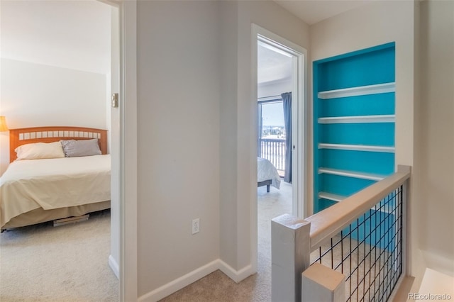 hall featuring carpet and baseboards