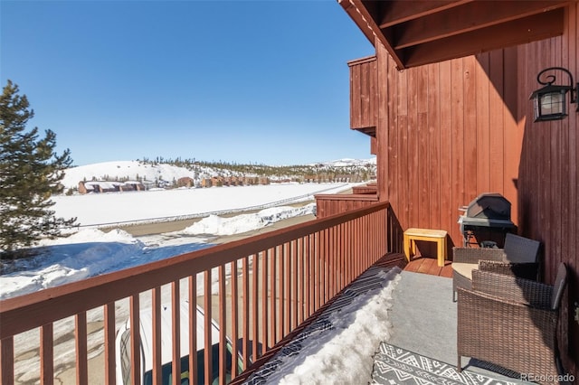 view of snow covered back of property