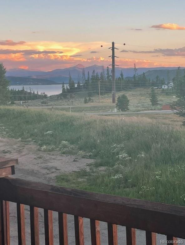 yard at dusk with a water and mountain view