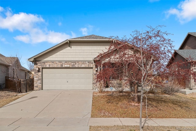 single story home featuring stone siding, an attached garage, and concrete driveway