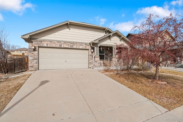 view of front of house featuring fence, an attached garage, covered porch, concrete driveway, and stone siding