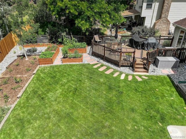 9356 W Geddes Pl, Littleton, CO 80128 - fenced backyard with a vegetable garden and a wooden deck