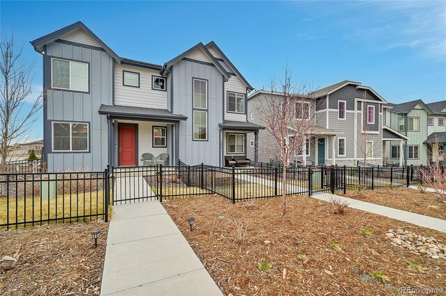 18059 French Creek Ave, Parker, CO 80134 - view of front of house featuring board and batten siding, a residential view, a fenced front yard, and a gate