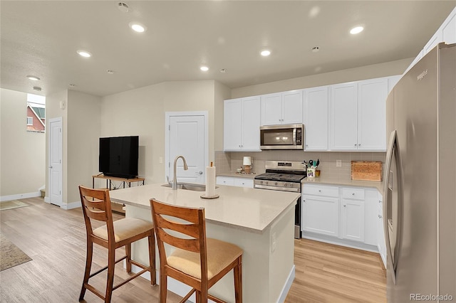 18059 French Creek Ave, Parker, CO 80134 - kitchen with a sink, stainless steel appliances, light wood finished floors, backsplash, and baseboards