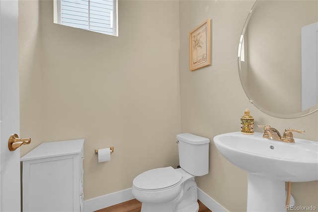 18059 French Creek Ave, Parker, CO 80134 - bathroom with a sink, toilet, wood finished floors, and baseboards