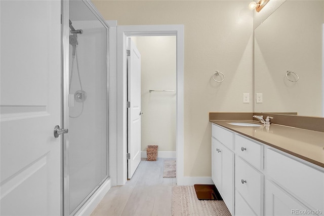 18059 French Creek Ave, Parker, CO 80134 - bathroom with baseboards, wood finished floors, vanity, and a shower stall