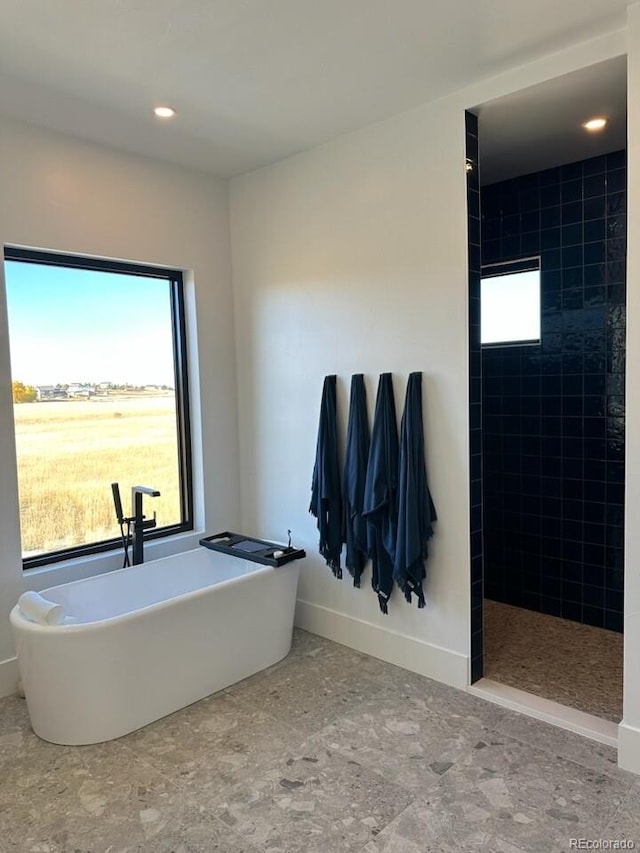 bathroom featuring independent shower and bath