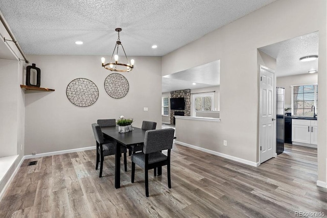 20908 E Dorado Cir, Centennial, CO 80015 - dining space featuring plenty of natural light, a textured ceiling, wood finished floors, baseboards, and recessed lighting