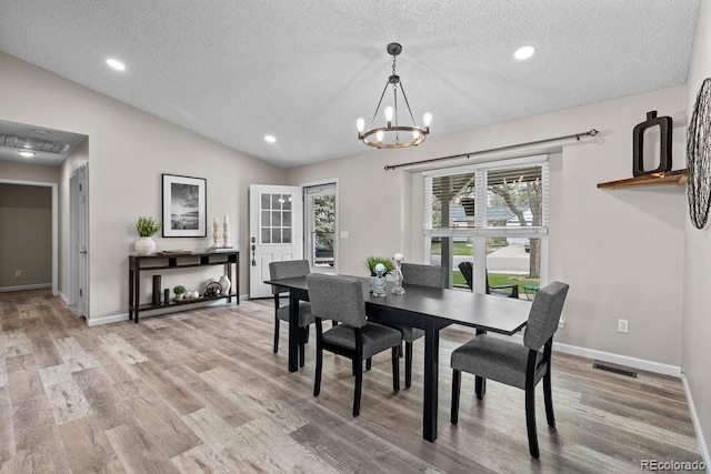 20908 E Dorado Cir, Centennial, CO 80015 - dining space with a textured ceiling, a chandelier, baseboards, wood finished floors, and lofted ceiling