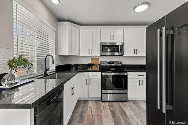 20908 E Dorado Cir, Centennial, CO 80015 - kitchen featuring black appliances, a sink, light wood-type flooring, white cabinetry, and backsplash