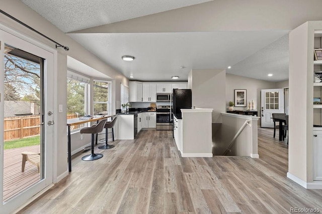 20908 E Dorado Cir, Centennial, CO 80015 - kitchen featuring black appliances, lofted ceiling, white cabinets, light wood-style flooring, and a sink