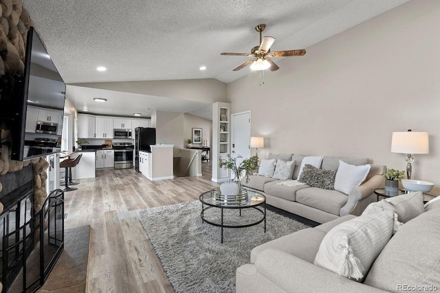 20908 E Dorado Cir, Centennial, CO 80015 - living area with light wood-style floors, ceiling fan, vaulted ceiling, a textured ceiling, and recessed lighting