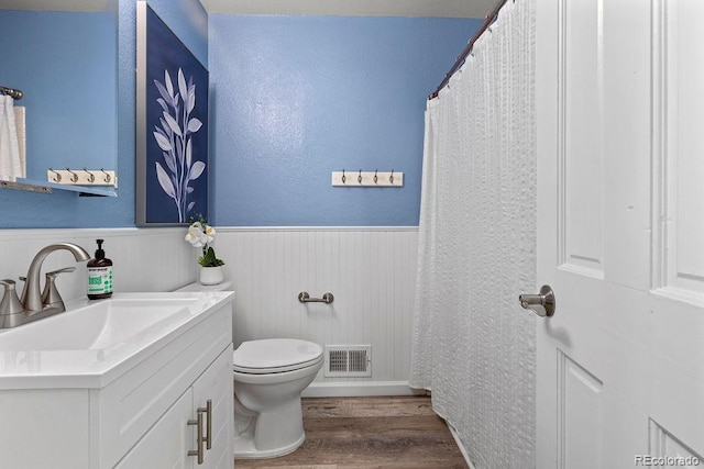 20908 E Dorado Cir, Centennial, CO 80015 - bathroom featuring wood finished floors, toilet, a wainscoted wall, a textured wall, and vanity