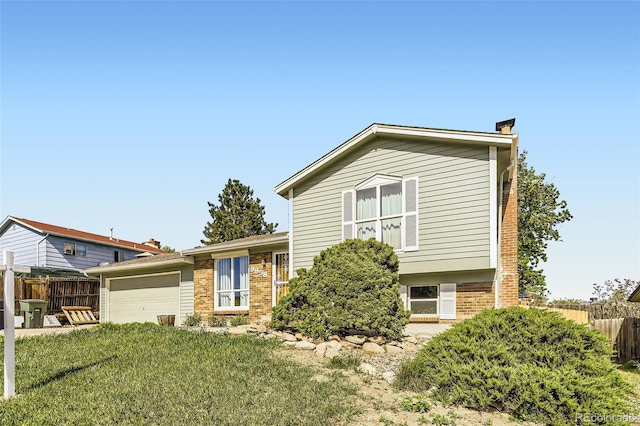 9958 Milwaukee St, Thornton, CO 80229 - split level home featuring a garage, a chimney, and brick siding