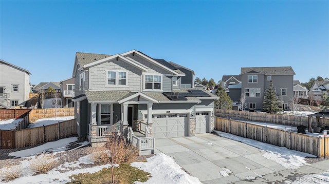 view of front of property featuring a garage and solar panels