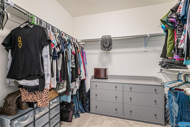 spacious closet featuring light carpet