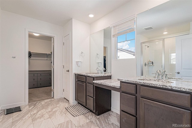 bathroom with vanity and a shower with shower door