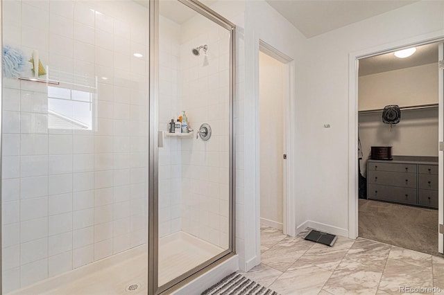 bathroom featuring a shower with door