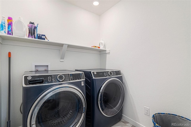 clothes washing area featuring independent washer and dryer