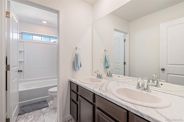 full bathroom featuring vanity, toilet, shower / bath combination, and a textured ceiling