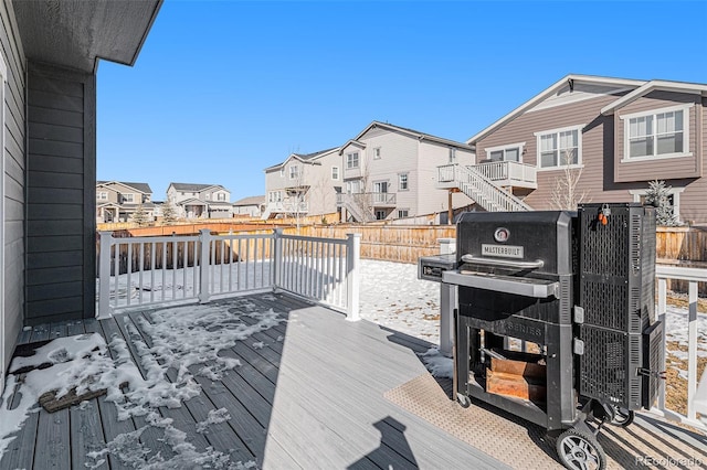 snow covered deck featuring a grill