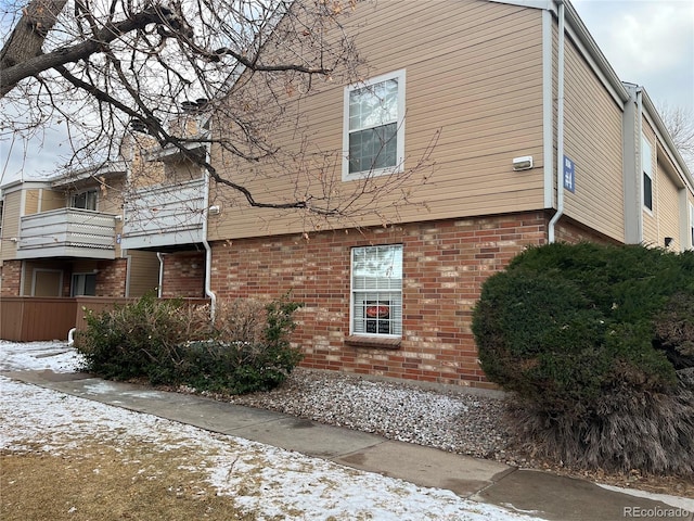 view of side of home featuring brick siding