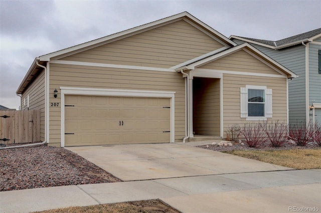 ranch-style home featuring a garage, driveway, and fence