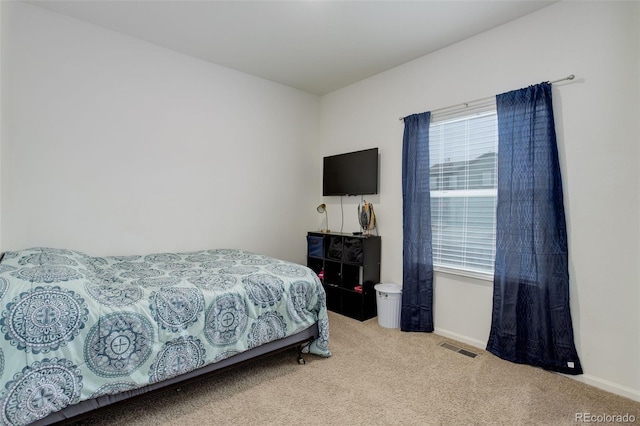 bedroom with baseboards, visible vents, and carpet flooring