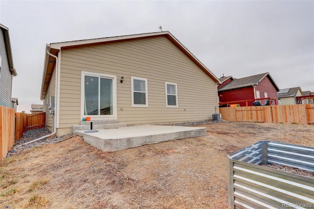 back of house with a patio area and a fenced backyard