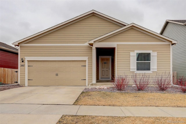 ranch-style house with driveway, an attached garage, and fence