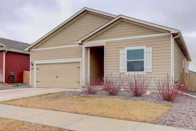 ranch-style home with a garage and driveway