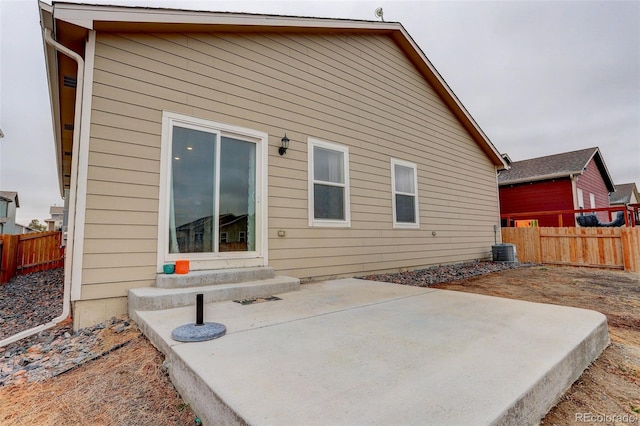 back of house with entry steps, a patio, fence, and central air condition unit