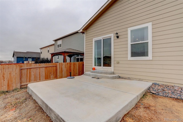 exterior space with entry steps, a gazebo, and fence