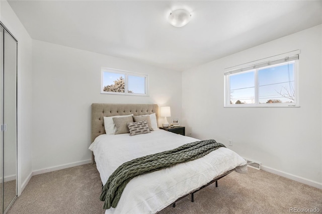 bedroom with light carpet and a closet