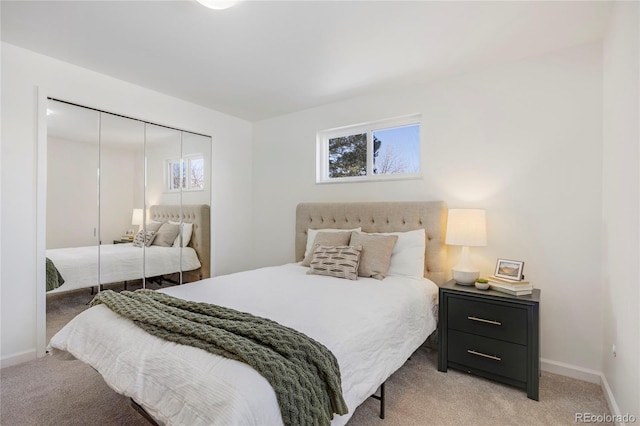 bedroom featuring light colored carpet and a closet