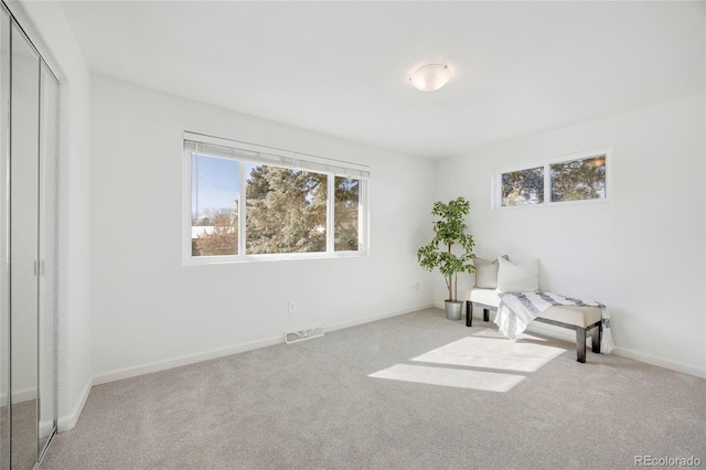 sitting room featuring light colored carpet