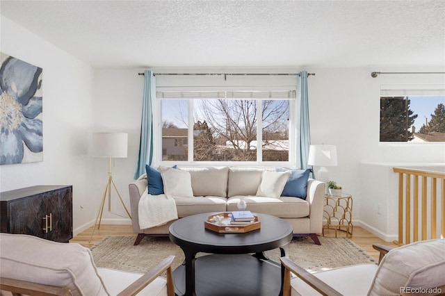 living room featuring a textured ceiling and light hardwood / wood-style flooring