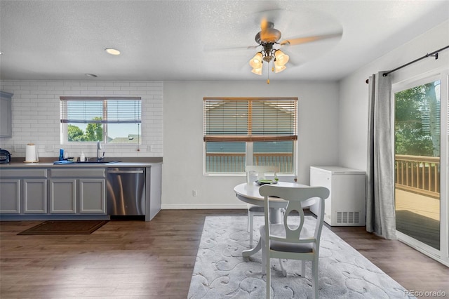2430 E 109th Dr, Northglenn, CO 80233 - dining room with ceiling fan, dark wood-style flooring, healthy amount of natural light, and a textured ceiling