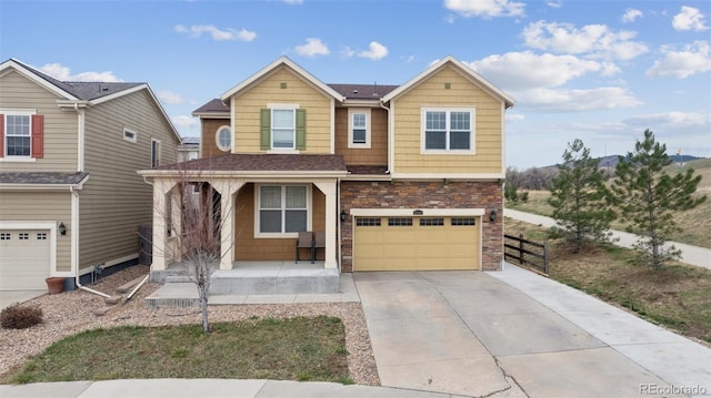 19760 W 59th Dr, Golden, CO 80403 - view of front of property featuring a porch, an attached garage, driveway, stone siding, and a shingled roof
