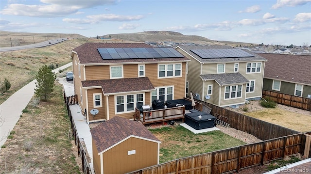 19760 W 59th Dr, Golden, CO 80403 - rear view of property featuring a fenced backyard, roof mounted solar panels, a deck with mountain view, and a residential view