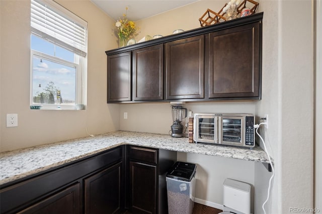 19760 W 59th Dr, Golden, CO 80403 - kitchen featuring dark brown cabinets and light stone counters