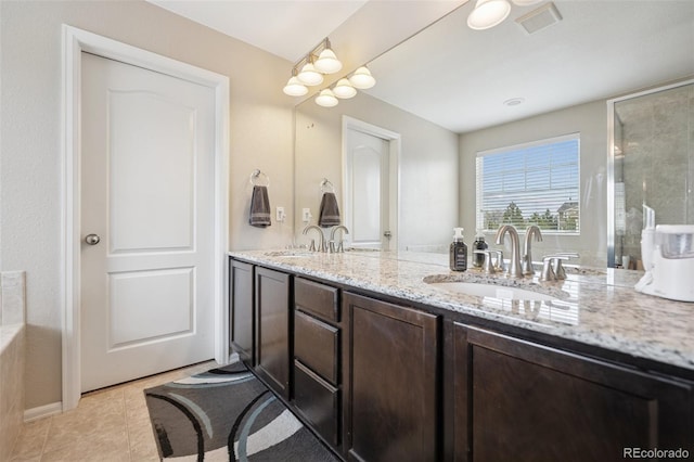 19760 W 59th Dr, Golden, CO 80403 - bathroom featuring double vanity, tile patterned flooring, and a shower with door