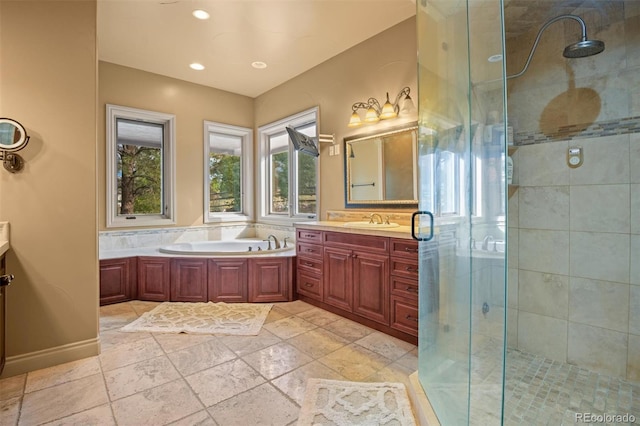 bathroom with tile patterned floors, vanity, and separate shower and tub