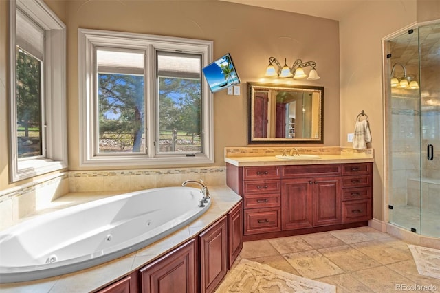 bathroom with tile patterned floors, vanity, a wealth of natural light, and plus walk in shower