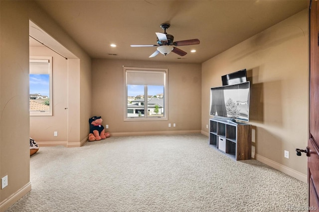 interior space featuring ceiling fan and light carpet